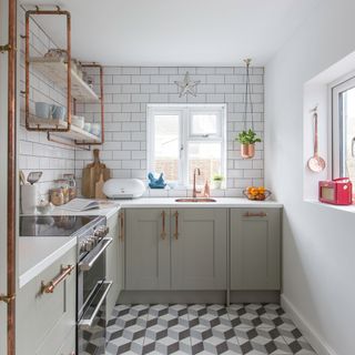 white tiled kitchen with wall shelves and grey cabinets