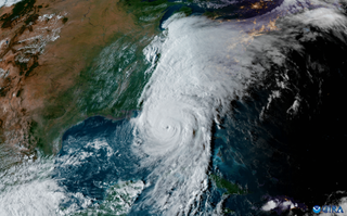 A hurricane is seen in satellite footage of Earth.