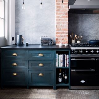 grey walled kitchen with cork flooring and blue drawers