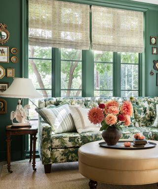 green living room with a floral couch and sheer window blinds