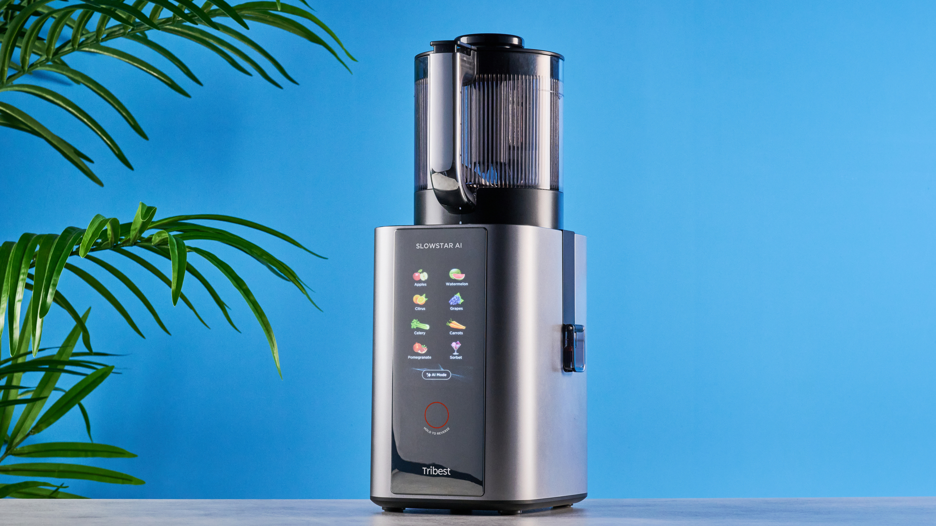 Tribest Slowstar AI Vertical Hopper Juicer photographed in front of a blue background