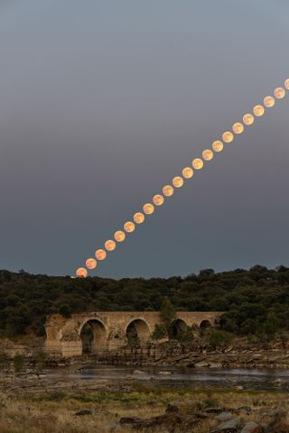 The Full Strawberry Moon rises over Ponte da Ajuda, a historic bridge near the border between Portugal and Spain, during the penumbral lunar eclipse on Friday (June 5). Astrophotographer Sérgio Conceição created this composite image of the rising moon from Elvas, Portugal, at the end of the eclipse. During this subtle lunar eclipse, the moon passed through the faint outer part of Earth's shadow, known as the penumbra, causing its surface to appear slightly tea-stained. "It can be seen that the moon was born with a more intense reddish pink color and started to whiten as it rose," Conceição told Space.com in an email.
