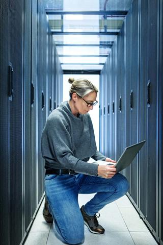 Woman engineer working in a server room