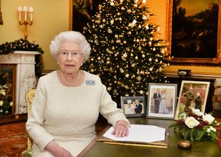 Queen Elizabeth II sits at a desk in the 18th Century Room at Buckingham Palace, after recording her Christmas Day broadcast in 2015