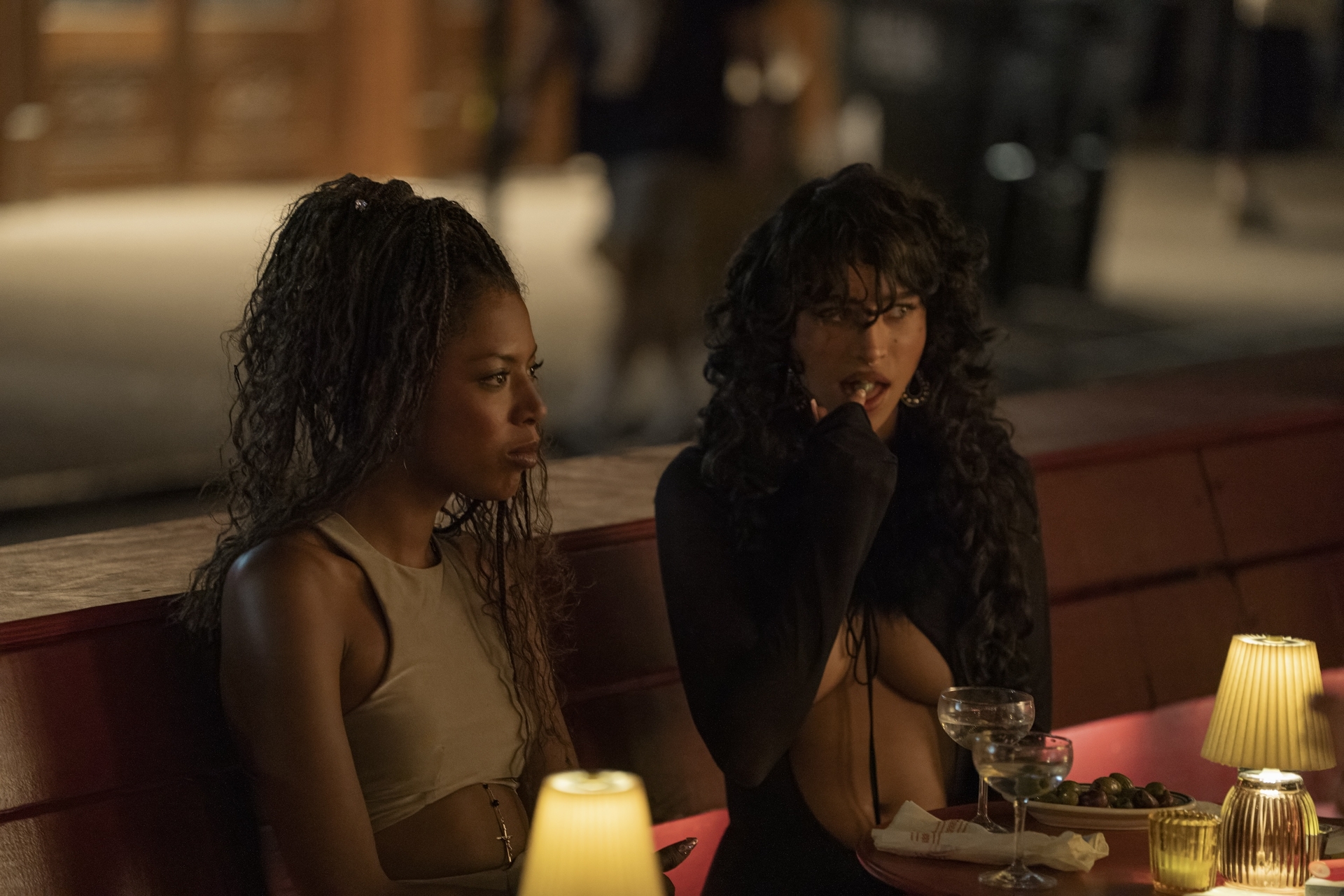 true whitaker as alani and odessa a'zion as tallulah eating dinner at a wine bar on a new york city street in a still from i love la season 1