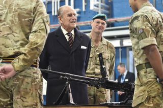 Prince Philip, Duke of Edinburgh (L), Colonel-in-Chief, Royal Electrical and Mechanical Engineers (REME) speaks to a soldier