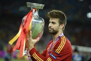 Gerard Pique celebrates with the European Championship trophy after winning Euro 2012