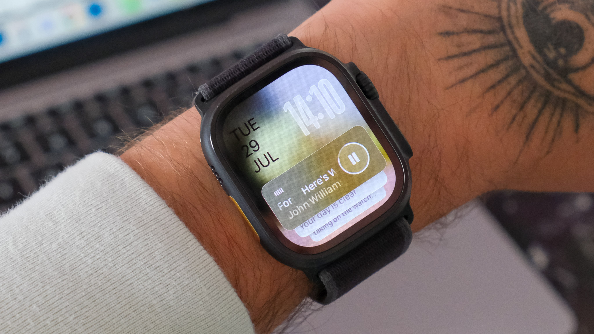Black Apple Watch Ultra 2 displaying watchOS 26