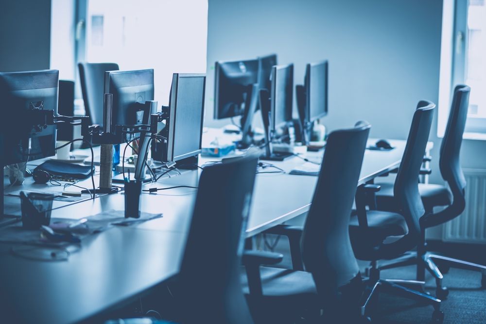 A row of desks in an empty office