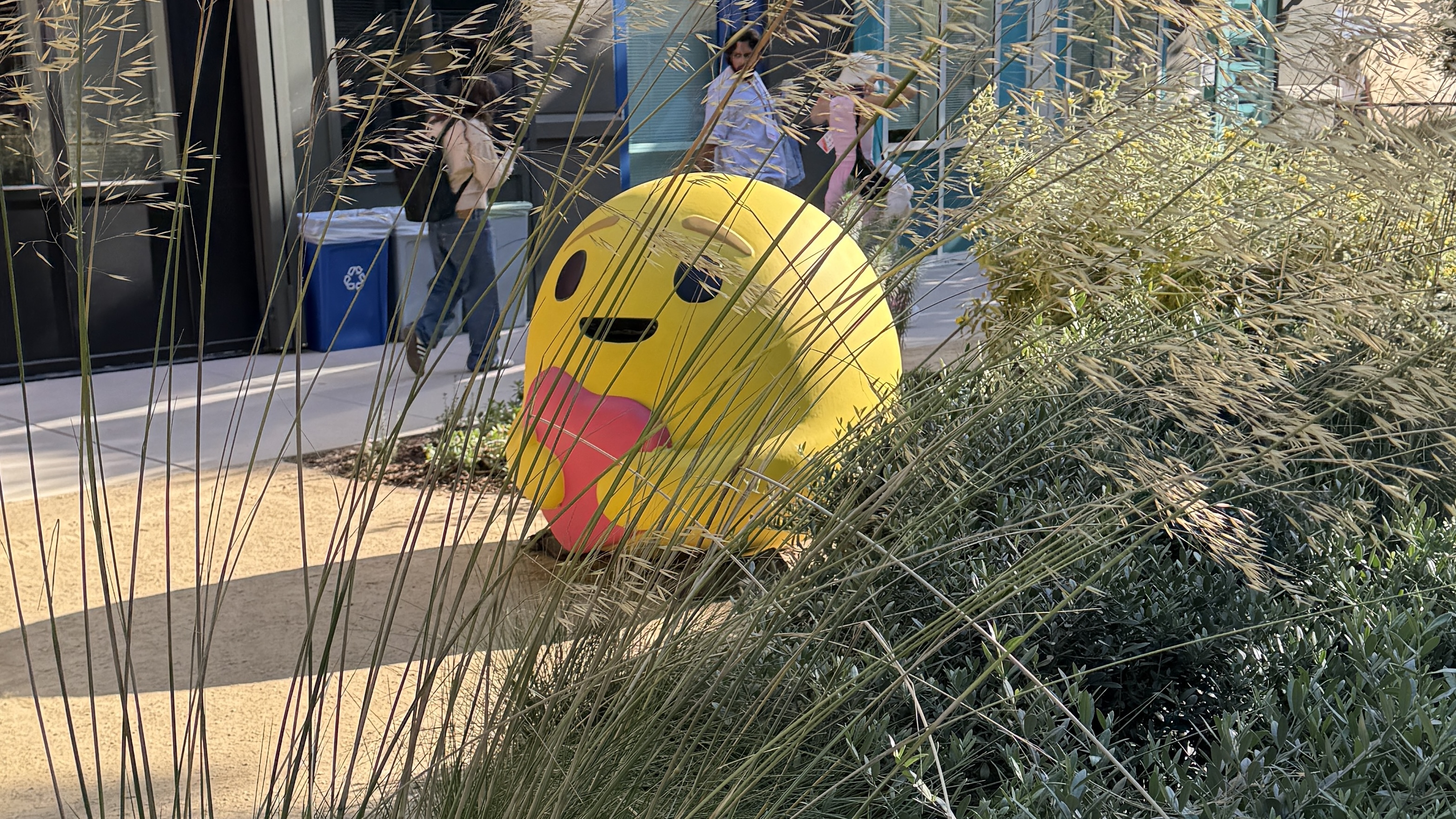 A yellow emoji head holding a large heart