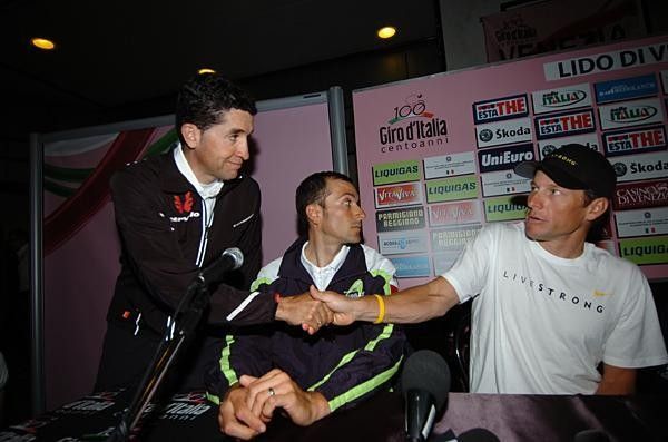 Carlos Sastre reaches across Ivan Basso