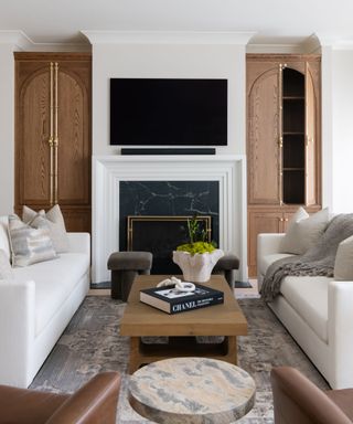 neutral timeless living room with accents of wood, marble and soft leather