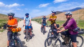 A group of bikepacking riders look over the view