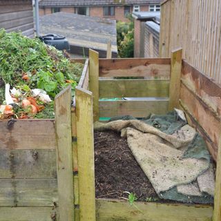 compost heap with wooden compost bin