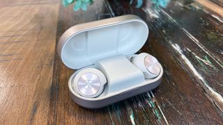 Bang & Olufsen Beoplay EQ review, headphones inside their case, with the case lid open, on a wooden table