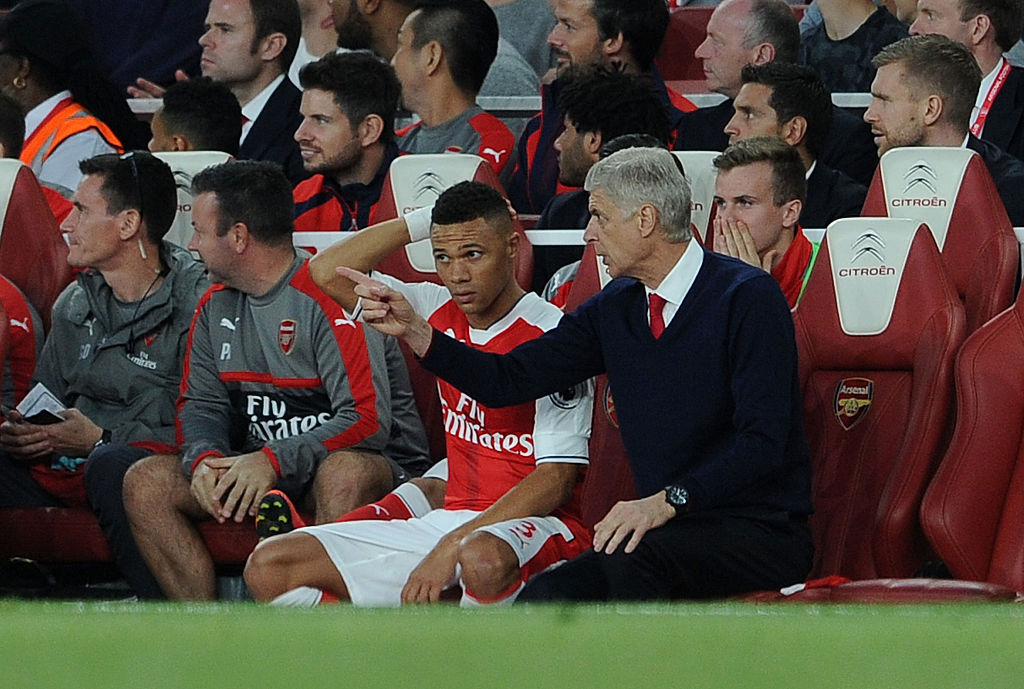 Arsene Wenger gives Kieran Gibbs some pointers from the dugout