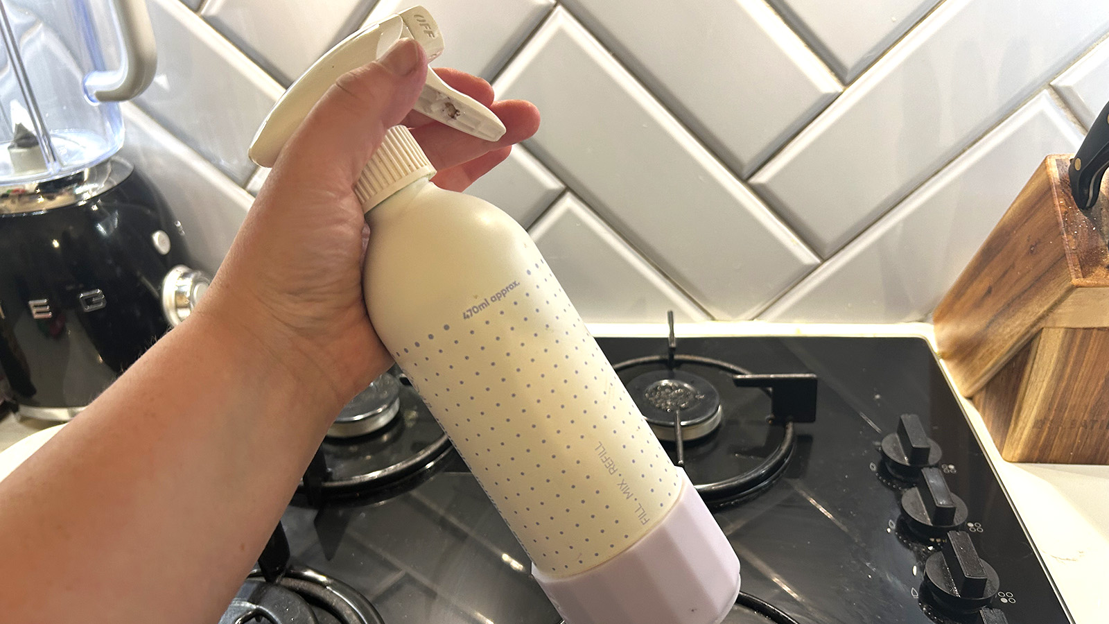 Homemade cleaning spray against a stovetop