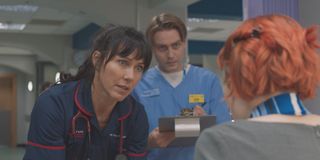 Cam looks on confused as Faith treats a patient.