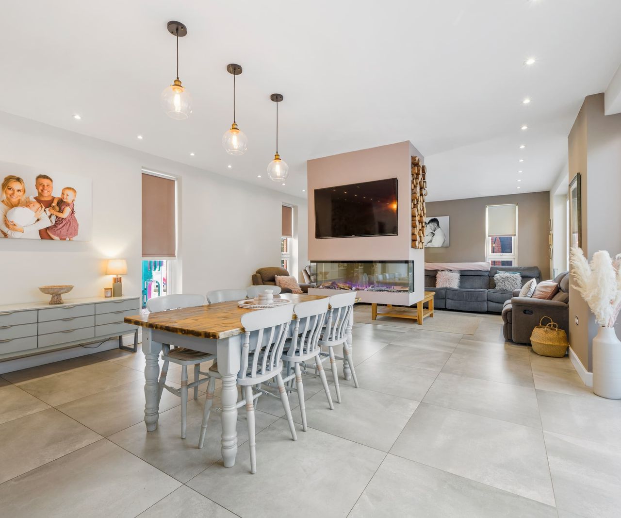 A kitchen dining room with a fireplace in the middle of the room