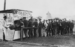 Soldiers of the Duke of Wellington's Regiment (West Riding) line up for Fish and Chips from a mobile shop set up in the Wathgill Camp during manoeuvers in August 1936 in Richmond, Yorkshire. Photos: Hulton Archive/Getty