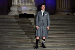 Oscar Isaac standing in a skirt at the London Moon Knight premiere.