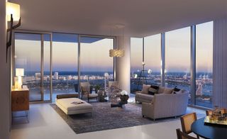 Inside an apartment at Missoni Baia with seating area and view of the city through glass windows