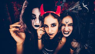 three women in dark and scary halloween costumes and paintings
