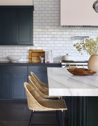 navy kitchen with rattan bar stools