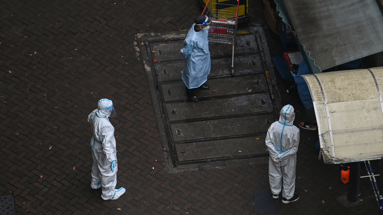 Health officials wearing PPE in streets of Shanghai