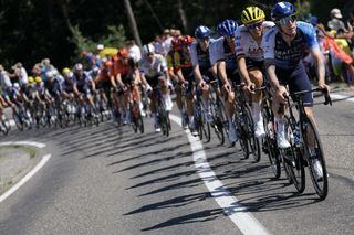 Israel - Premier Tech team's British rider Jake Stewart leads the pack of riders (peloton) during the 18th stage of the 111th edition of the Tour de France cycling race, 179,5 km between Gap and Barcelonnette, in the French Alps in southeastern France, on July 18, 2024. (Photo by Thomas SAMSON / AFP) (Photo by THOMAS SAMSON/AFP via Getty Images)