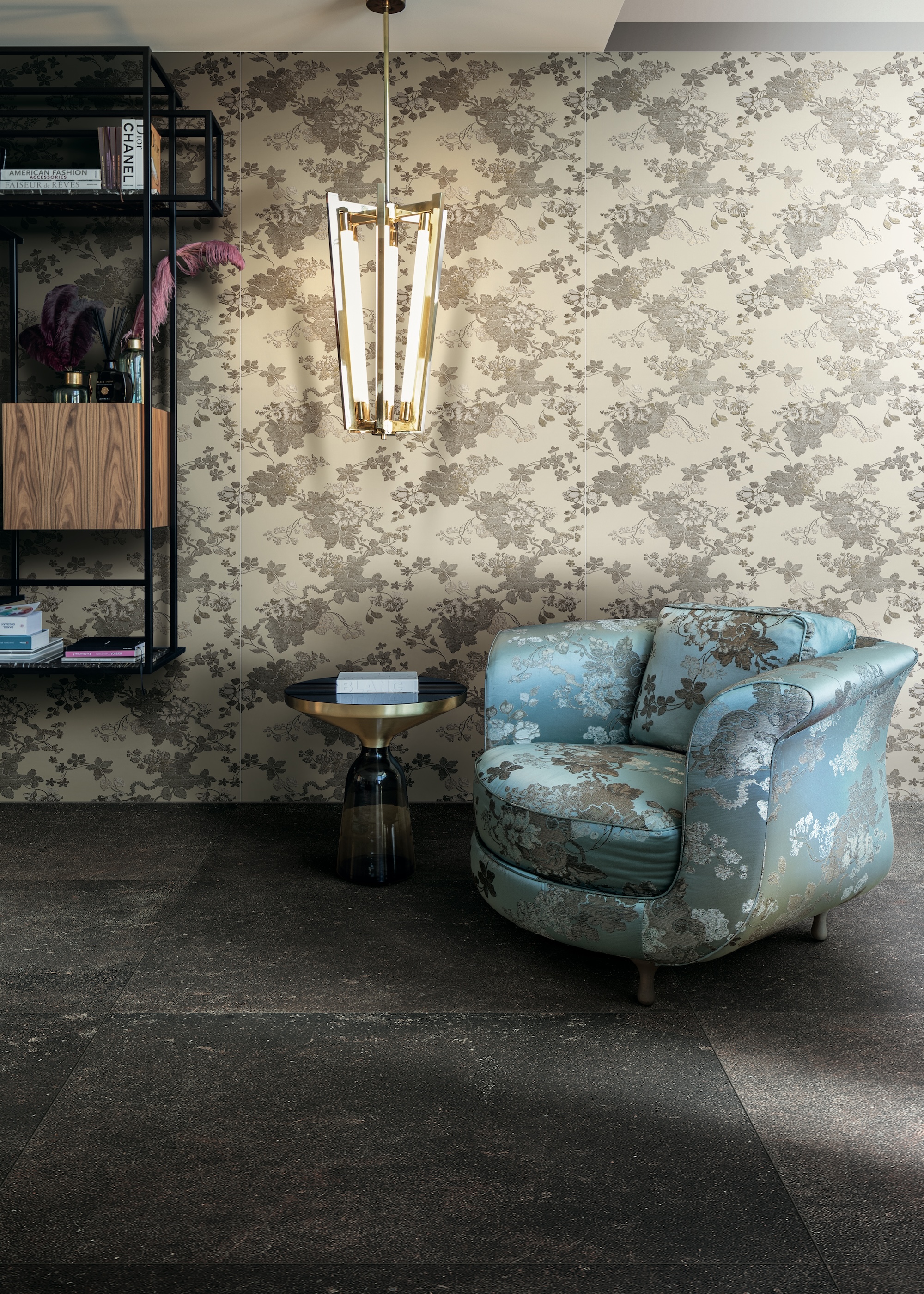 a room with a floral print wall tile with modern lighting and a floral armchair