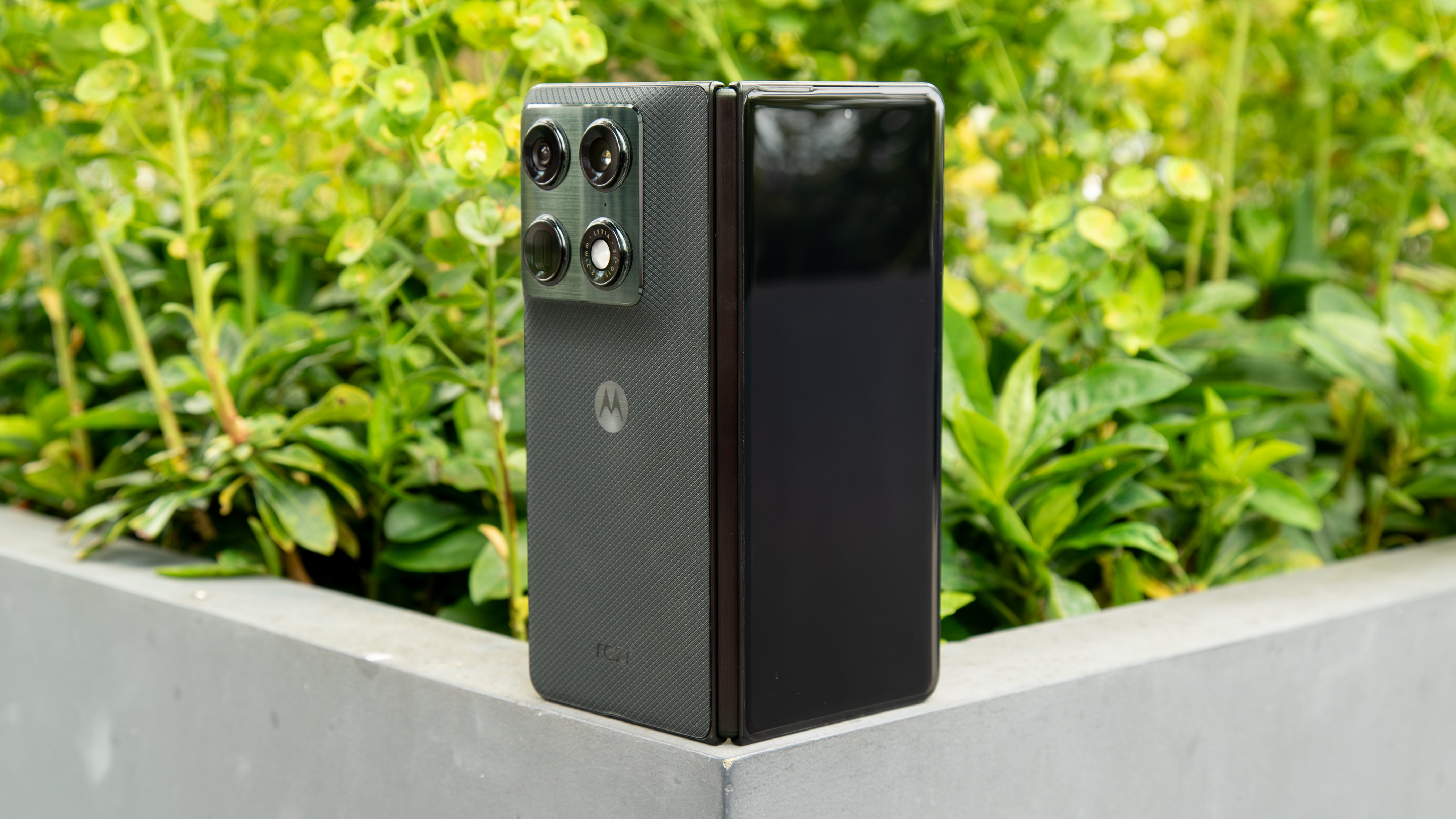 Motorola Razr Fold on the corner of a planter