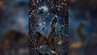 The Hubble Space Telescope captured this infrared image of the Pillars of Creation in the Eagle Nebula. The light from young stars being formed can be seen piercing the clouds of dust and gas.