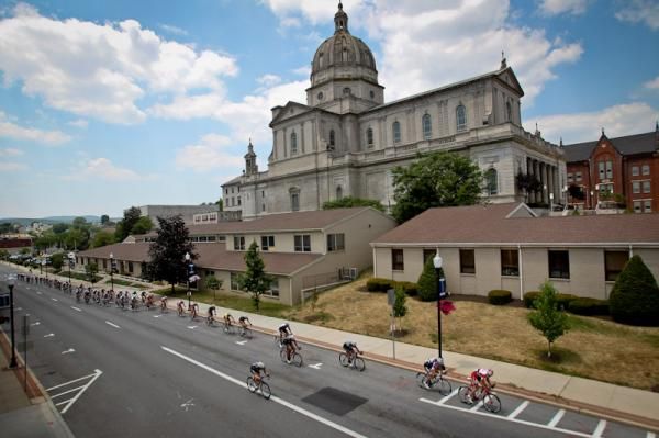 Riders get strung out alongside a church on the back side of the course.