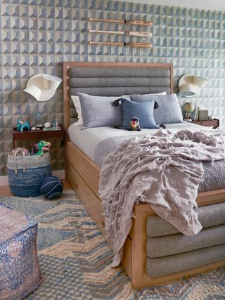 Blue boys bedroom with double bed and blue patterned wallpaper