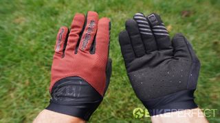 The top of the hand and palm of the gloves being shown side by side while worn