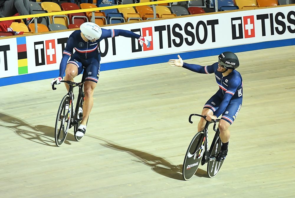 France's Francois Pervis (L) celebrates with teammate Quentin Lafargue after their victory in the men's team sprint bronze final race against Russia
