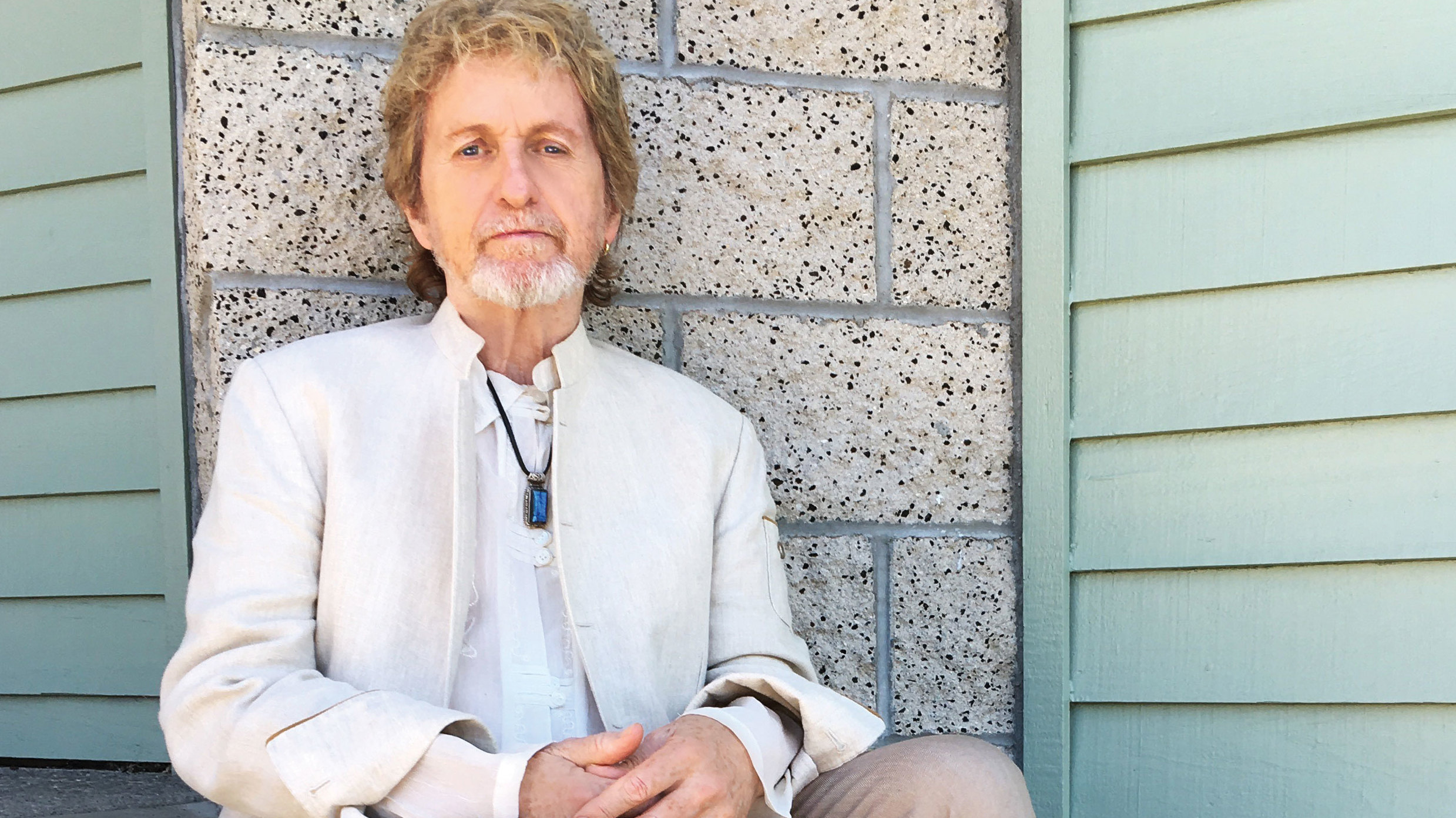 Jon Anderson leaning against a wall