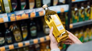 woman browsing cooking oils at a grocery store