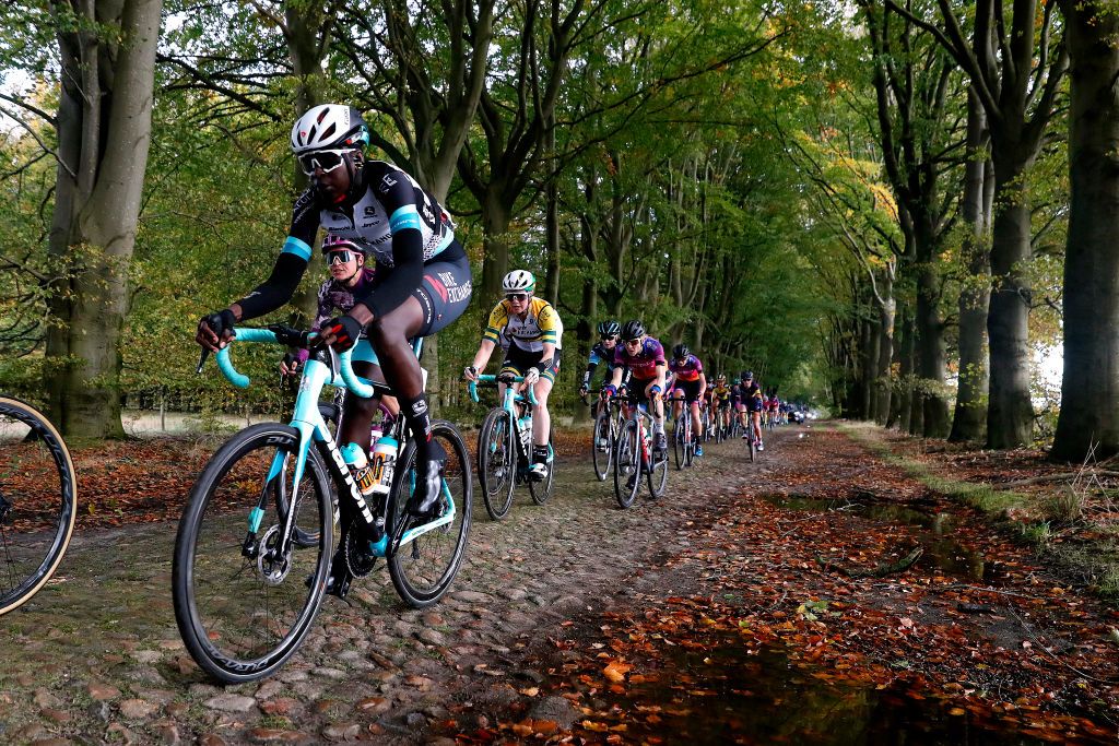 HOOGEVEEN NETHERLANDS OCTOBER 23 LR Teniel Campbell of Trinidad And Tobago and Team BikeExchange Sofia Bertizzolo of Italy and Team Liv Racing and Sarah Roy of Australia and Team BikeExchange compete through cobblestones sector during the 17th UCI Womens WorldTour Ronde van Drenthe 2021 a 1591km one day race from Assen to Hoogeveen UCIWWT RondevDrenthe on October 23 2021 in Hoogeveen Netherlands Photo by Bas CzerwinskiGetty Images