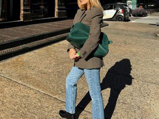 Morgan Stewart blazer jeans and loafer outfit with green the row margaux oversized clutch