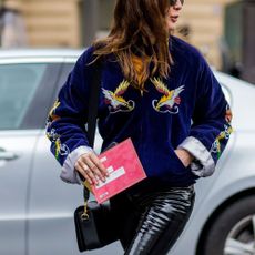 A woman wearing patent leather trousers.