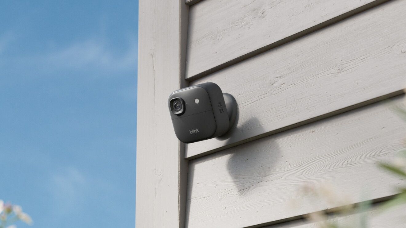 A Blink security camera attached to the side of a building