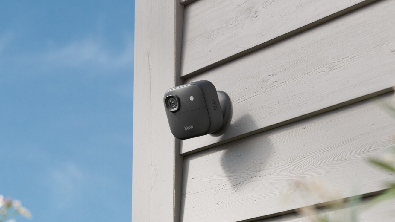 A Blink security camera attached to the side of a building