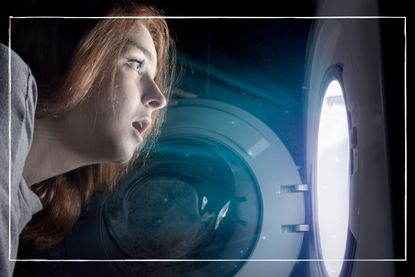a women looking into an electric washing machine at night