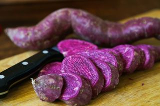 purple sweet potatoes on a chopping board