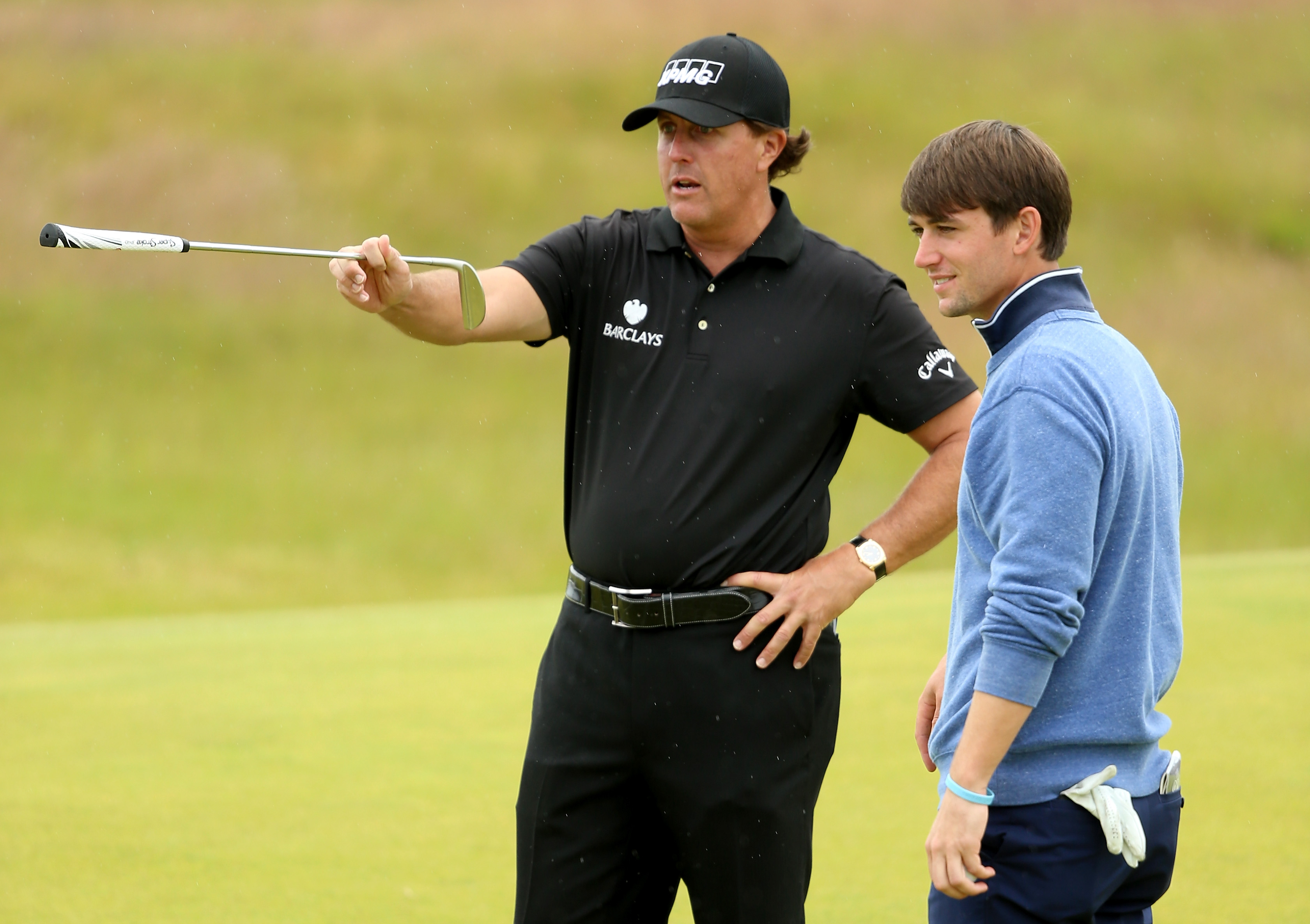 Phil Mickelson points something out to Ollie Schniederjans with his putter at the 2015 Open Championship