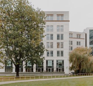 Off-white exterior of the Oper46 office building in Frankfurt during the day