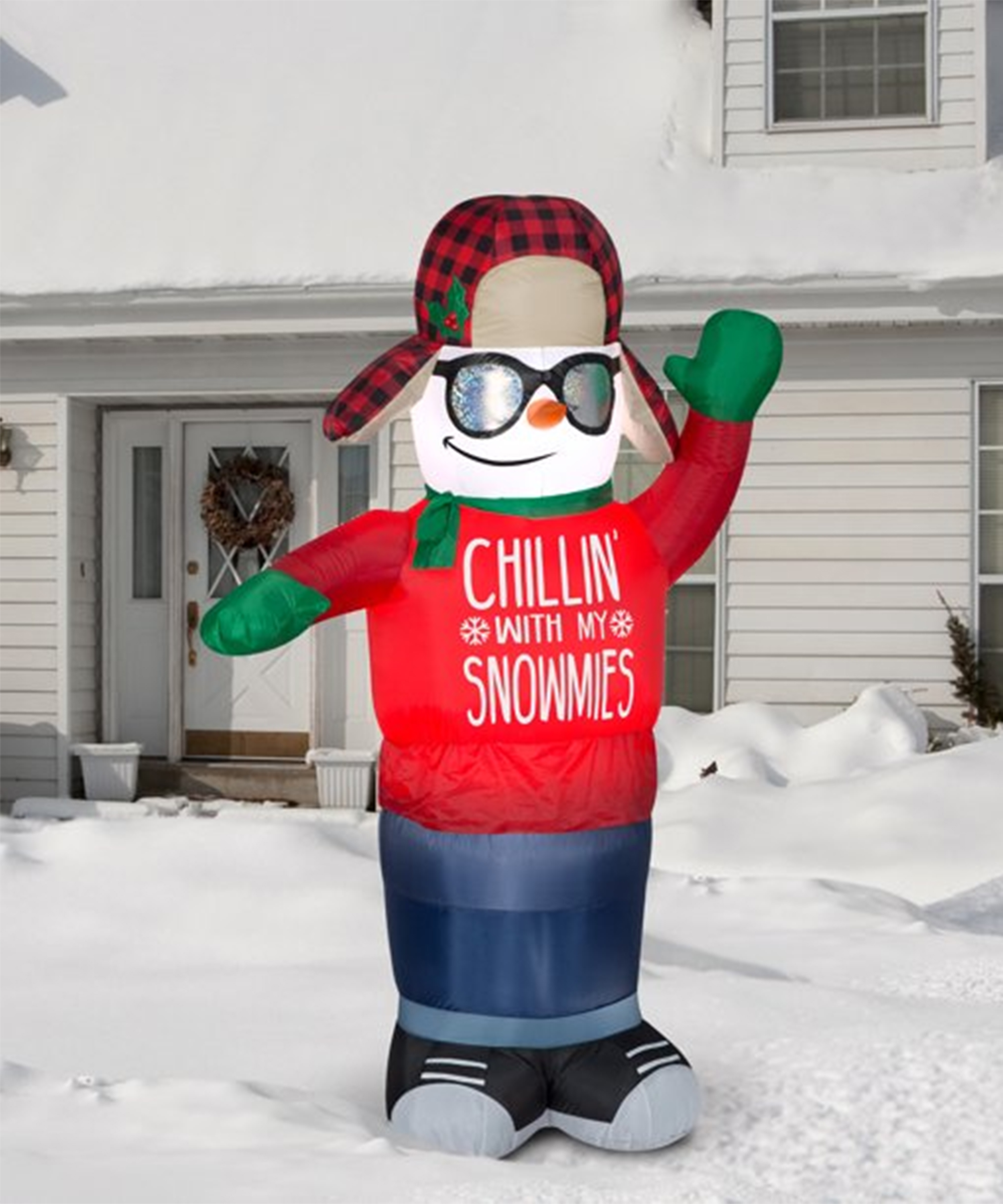 An inflatable exterior Christmas snowman decoration with 'Chillin' with my snowmies' slogan on tee shirt