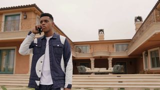 Jabari Banks on the phone outside a mansion in Bel-Air
